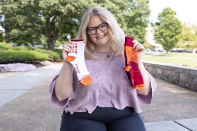 Madison Gunnell holding this year's Hokie socks designs.